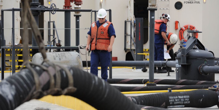 Coast Guard officers inspect an oil barge in Tacoma, Wash.