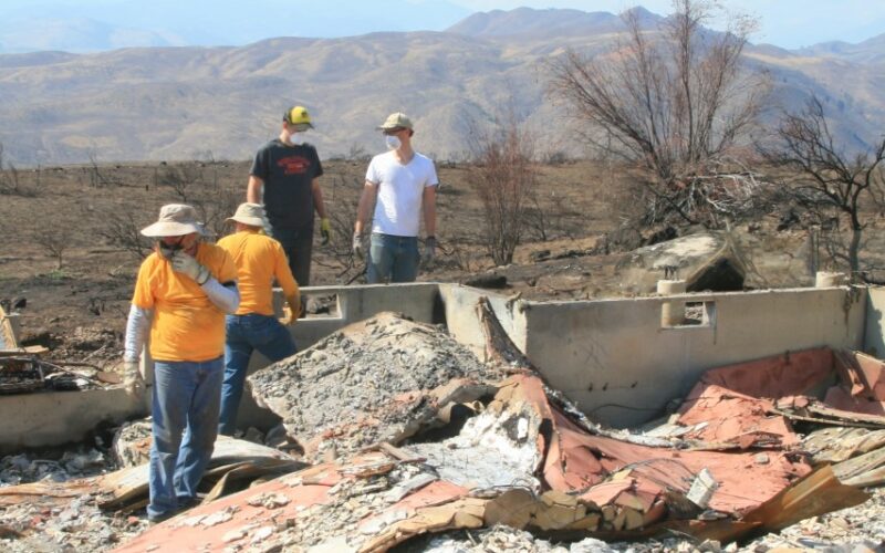 A crew of Southern Baptists from California looks for items that survived fire in the Methow Valley, hoping to give homeowners some closure. (Photo by Marcy Stamper for the Methow Valley News)