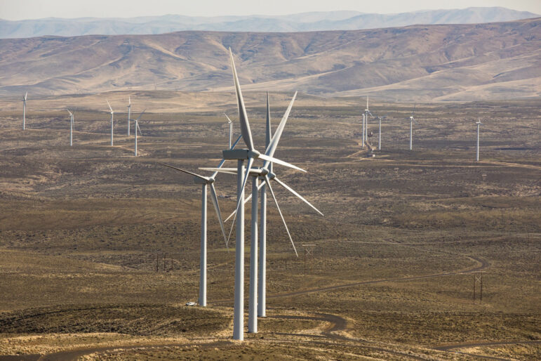 Wind turbines on a brown landscape.